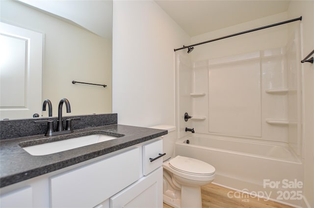 full bathroom featuring shower / bath combination, vanity, toilet, and wood finished floors