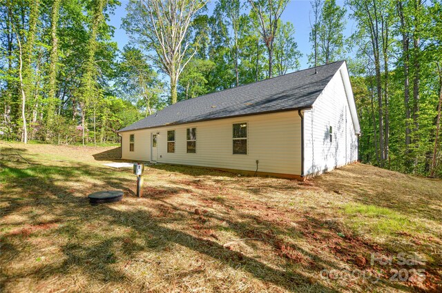 view of side of home with a lawn