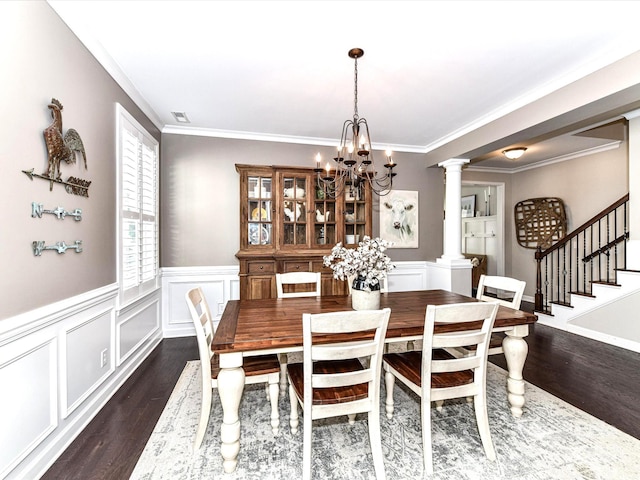 3057 Drummond Ave, Indian Land, SC 29707 - dining area featuring dark wood-style flooring, crown molding, a wainscoted wall, an inviting chandelier, and ornate columns