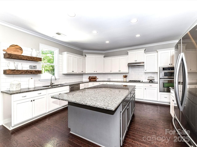3057 Drummond Ave, Indian Land, SC 29707 - kitchen featuring crown molding, a sink, under cabinet range hood, stainless steel appliances, and white cabinetry