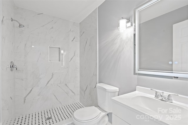 full bathroom featuring toilet, vanity, and a marble finish shower