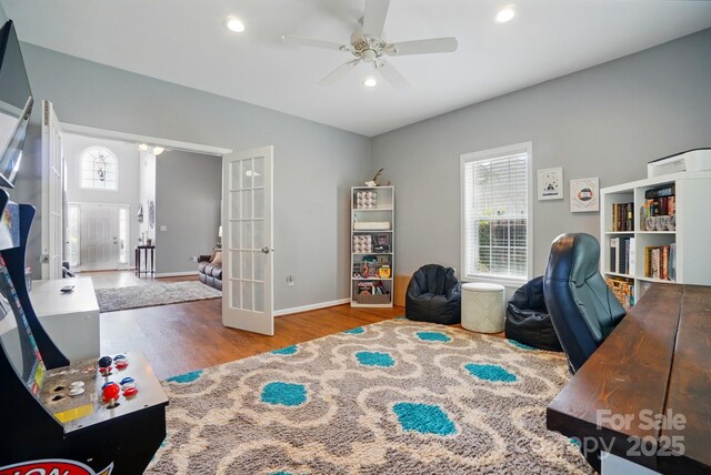 home office with ceiling fan, french doors, wood finished floors, and a wealth of natural light