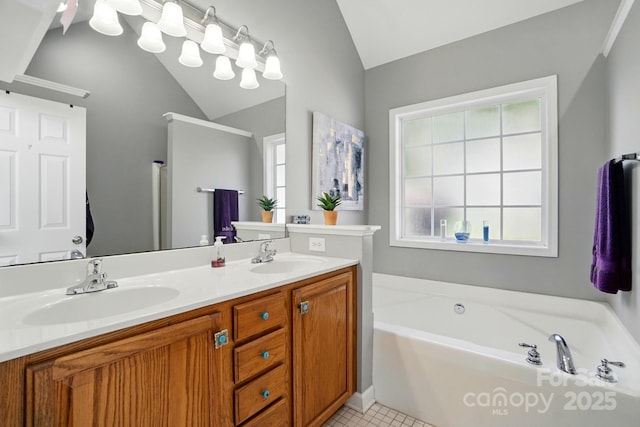 bathroom featuring a sink, plenty of natural light, and lofted ceiling