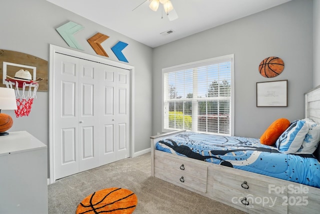 carpeted bedroom featuring baseboards, ceiling fan, a closet, and visible vents