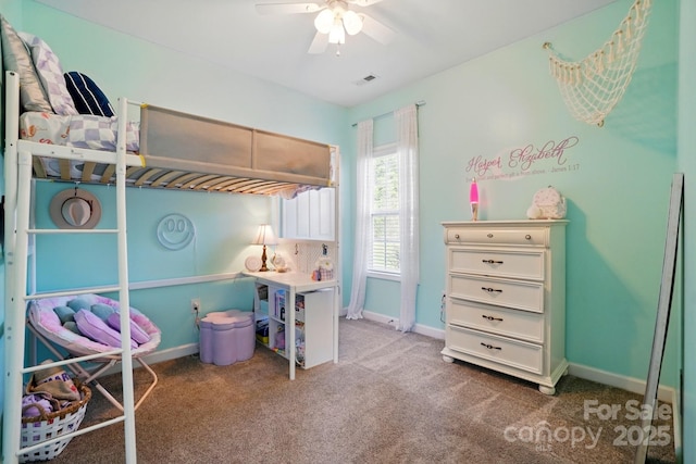 carpeted bedroom featuring baseboards, ceiling fan, and visible vents