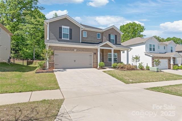 1020 Clementine Rd, Monroe, NC 28110 - view of front of property featuring brick siding, a garage, driveway, and central AC