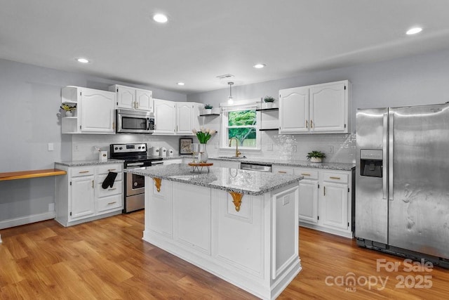 4009 Dunwoody Dr, Charlotte, NC 28215 - kitchen with open shelves, appliances with stainless steel finishes, a sink, white cabinetry, and recessed lighting