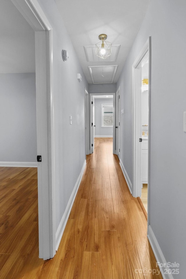 4009 Dunwoody Dr, Charlotte, NC 28215 - corridor with attic access, light wood finished floors, and baseboards