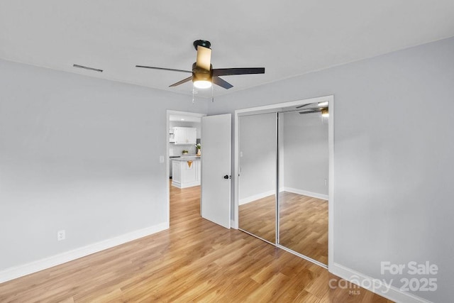 4009 Dunwoody Dr, Charlotte, NC 28215 - unfurnished bedroom featuring light wood-style flooring, a closet, baseboards, and a ceiling fan