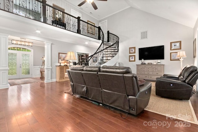living area with high vaulted ceiling, visible vents, ornate columns, and ceiling fan