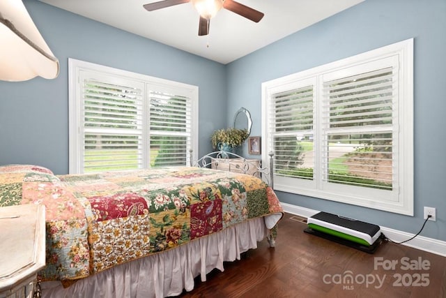 bedroom featuring ceiling fan, baseboards, and wood finished floors