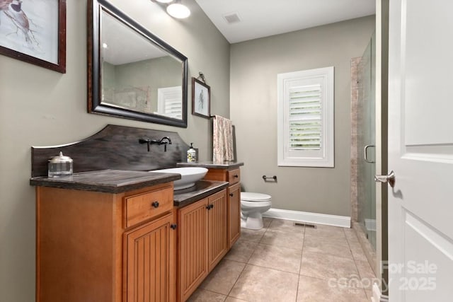 bathroom featuring toilet, vanity, tile patterned floors, and visible vents