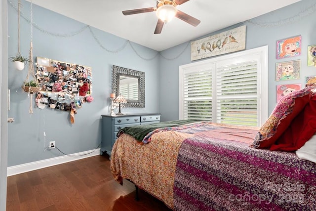 bedroom with baseboards, a ceiling fan, wood finished floors, and multiple windows