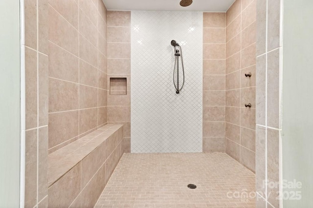 bathroom featuring a tile shower