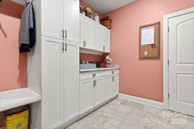 washroom with baseboards
