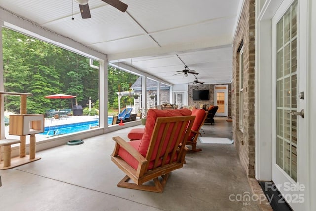 view of patio / terrace with a ceiling fan and an outdoor pool