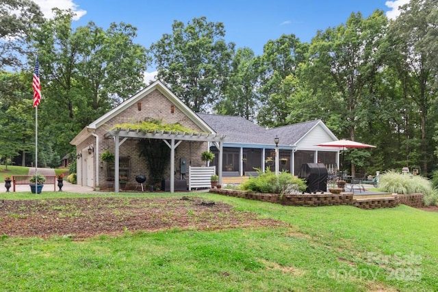 view of front of home featuring a pergola, a patio area, an attached garage, a sunroom, and a front yard