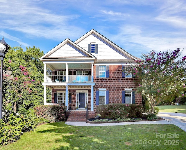 1105 Hoyle Ln, Waxhaw, NC 28173 - view of front of home featuring brick siding, a porch, a front yard, and a balcony