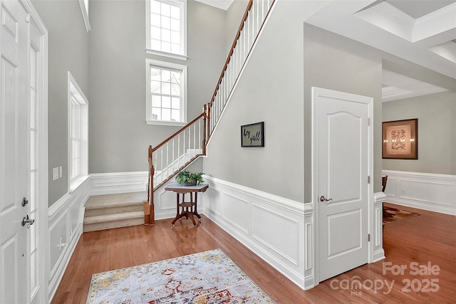 1105 Hoyle Ln, Waxhaw, NC 28173 - entrance foyer featuring wood finished floors, a wainscoted wall, and stairs