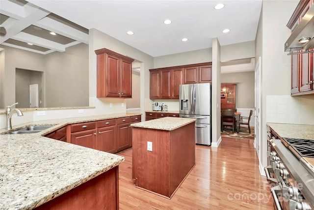 1105 Hoyle Ln, Waxhaw, NC 28173 - kitchen featuring light wood finished floors, ventilation hood, a sink, and appliances with stainless steel finishes