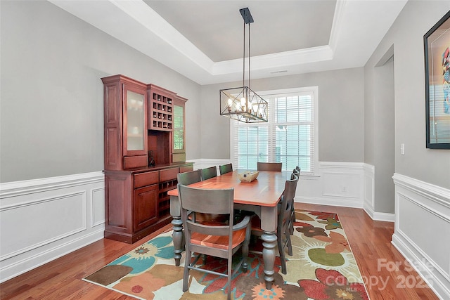 1105 Hoyle Ln, Waxhaw, NC 28173 - dining room featuring wainscoting, a healthy amount of sunlight, dark wood-type flooring, and a raised ceiling
