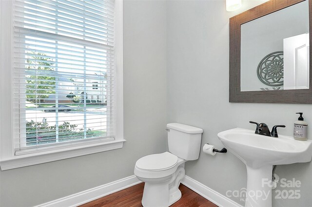1105 Hoyle Ln, Waxhaw, NC 28173 - half bathroom featuring wood finished floors, toilet, and baseboards