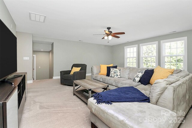 1105 Hoyle Ln, Waxhaw, NC 28173 - living area featuring visible vents, a ceiling fan, baseboards, and light carpet