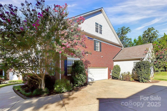 1105 Hoyle Ln, Waxhaw, NC 28173 - view of property exterior featuring brick siding, driveway, and a garage