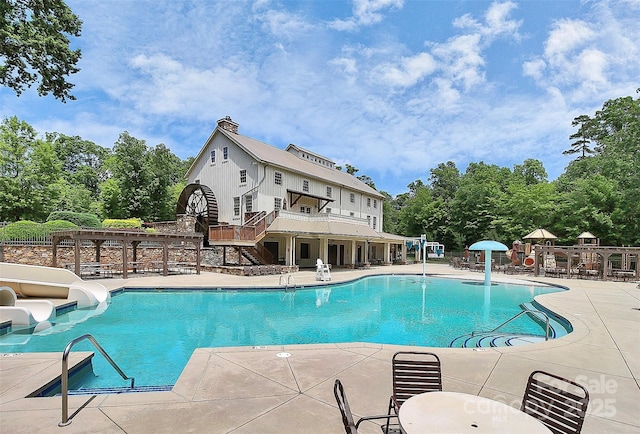 1105 Hoyle Ln, Waxhaw, NC 28173 - pool featuring a water slide, fence, a patio area, and stairs