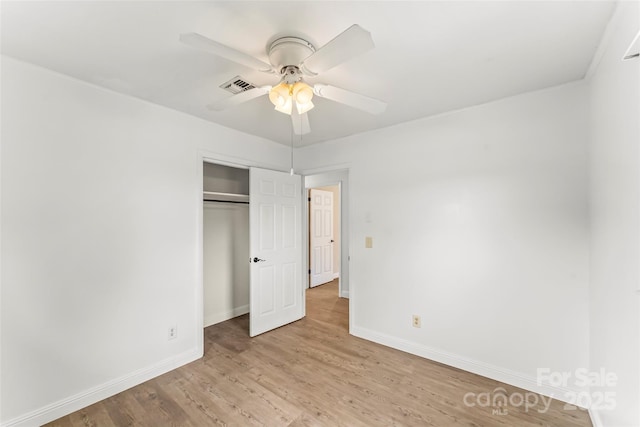 unfurnished bedroom with baseboards, visible vents, and light wood-style floors