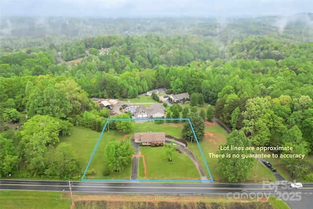 aerial view featuring a wooded view