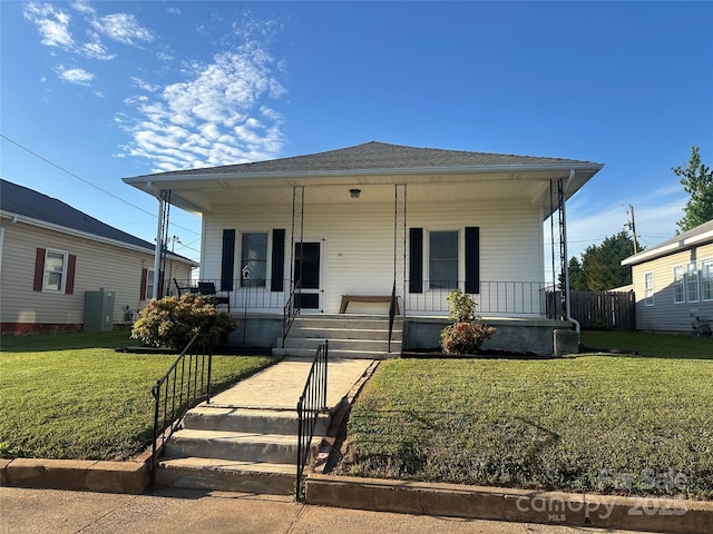 bungalow-style house featuring a front lawn, fence, and a porch