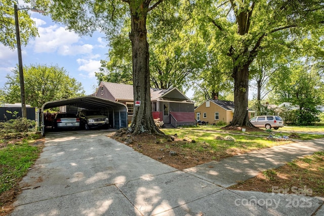 3919 Sarah Dr Unit 14, Charlotte, NC 28217 - view of front of home featuring a detached carport, driveway, and a front yard