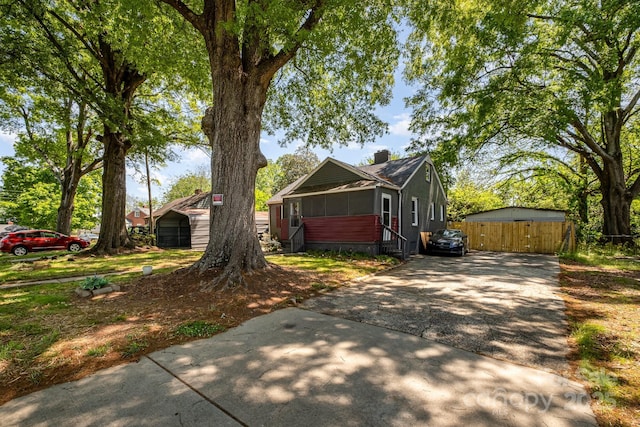3919 Sarah Dr Unit 14, Charlotte, NC 28217 - view of side of home featuring a gate, driveway, a chimney, and fence