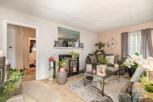 3919 Sarah Dr Unit 14, Charlotte, NC 28217 - carpeted living room with baseboards, a textured wall, a textured ceiling, and a fireplace