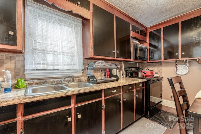 3919 Sarah Dr Unit 14, Charlotte, NC 28217 - kitchen with decorative backsplash, light countertops, a sink, and black appliances