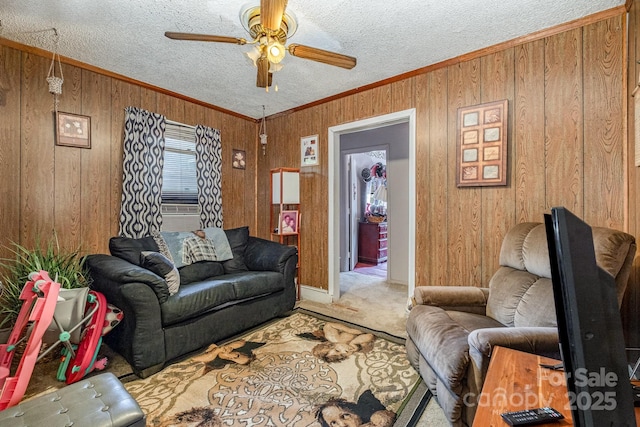 3919 Sarah Dr Unit 14, Charlotte, NC 28217 - living area with wood walls, carpet floors, ceiling fan, and crown molding