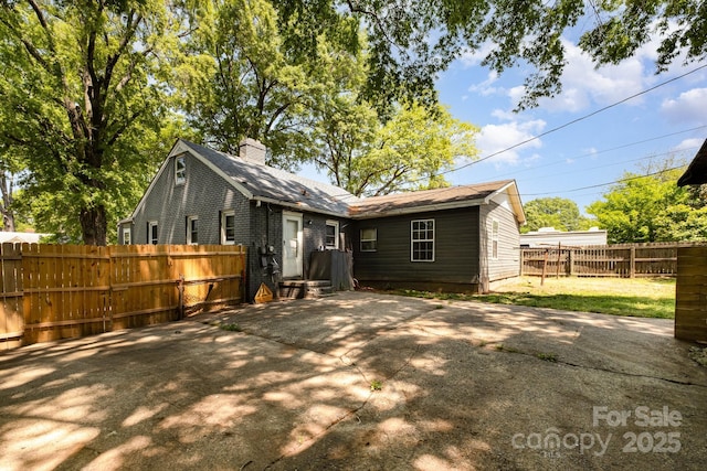 3919 Sarah Dr Unit 14, Charlotte, NC 28217 - rear view of property featuring a chimney, fence, and a patio area