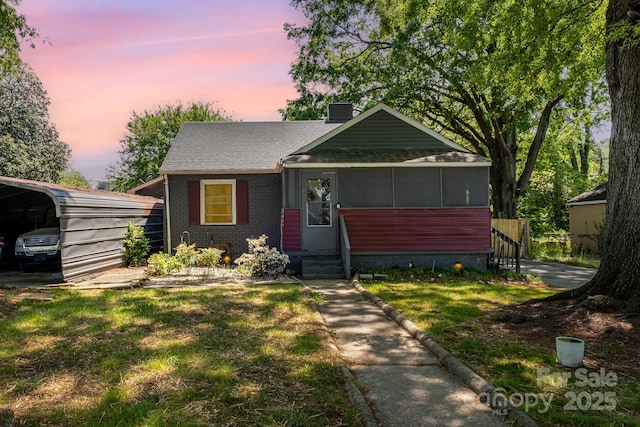 3919 Sarah Dr Unit 14, Charlotte, NC 28217 - view of front facade with a chimney, a front lawn, brick siding, a detached carport, and roof with shingles