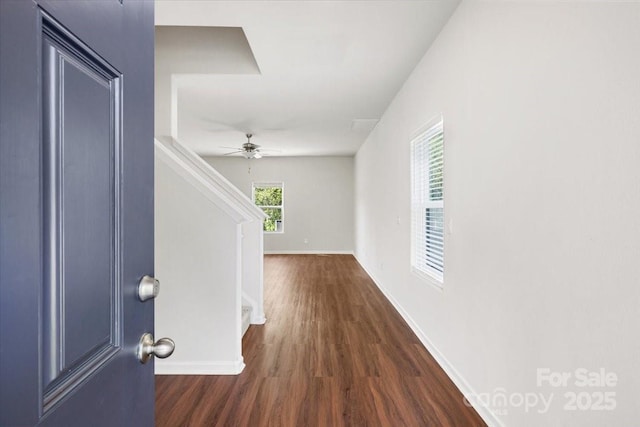 foyer entrance featuring ceiling fan, baseboards, stairway, and dark wood finished floors