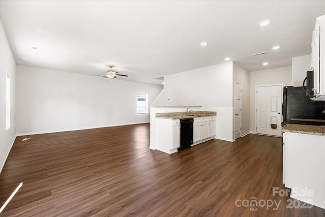 kitchen with a sink, ceiling fan, baseboards, white cabinetry, and light stone countertops