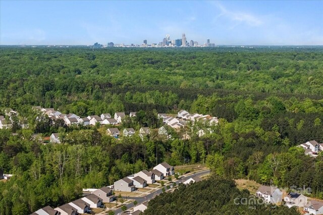 birds eye view of property with a view of trees and a residential view
