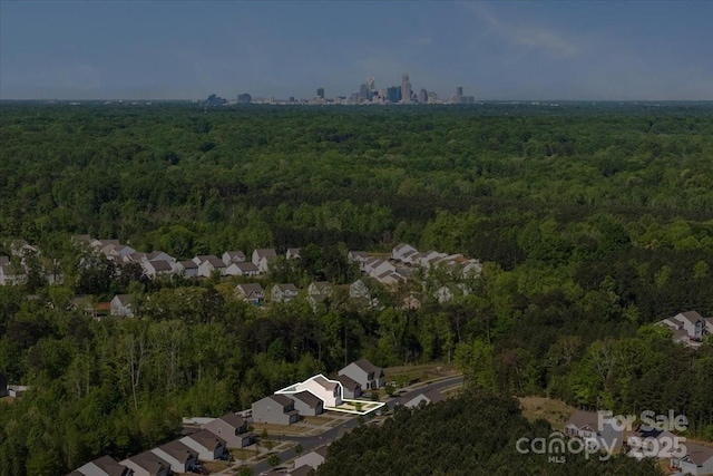 bird's eye view featuring a view of trees and a residential view