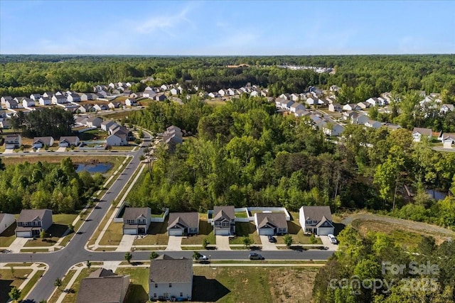 aerial view featuring a view of trees and a residential view