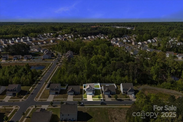 aerial view with a forest view and a residential view