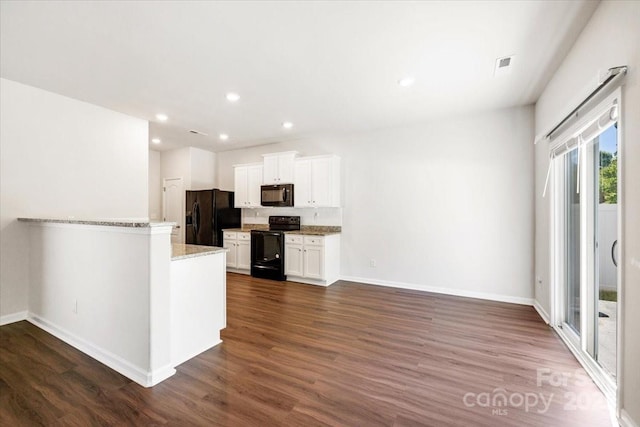kitchen with black appliances, baseboards, dark wood-style flooring, and white cabinets
