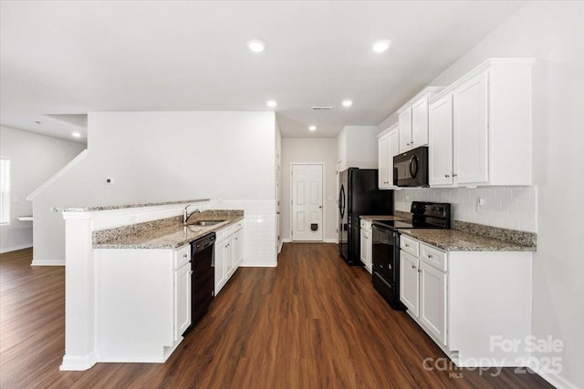 kitchen featuring black appliances, dark wood-style flooring, a sink, and white cabinetry