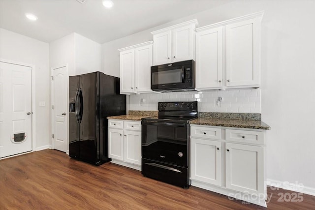 kitchen with black appliances, white cabinetry, and stone countertops