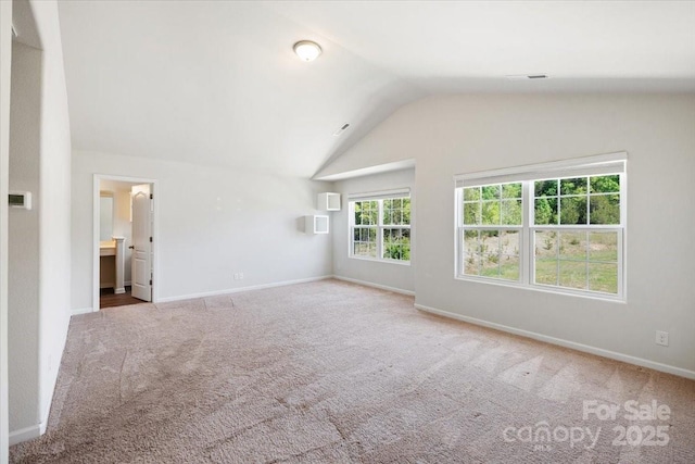 unfurnished living room featuring vaulted ceiling, visible vents, carpet floors, and baseboards
