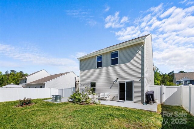 back of property featuring a lawn, a fenced backyard, and a patio